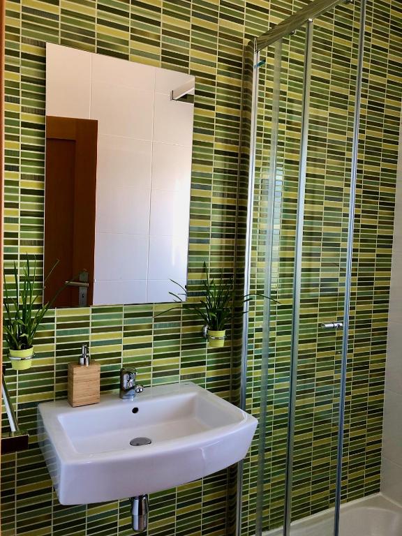 a bathroom with a sink and a mirror at Âncora Boutique Apartments in Lagos
