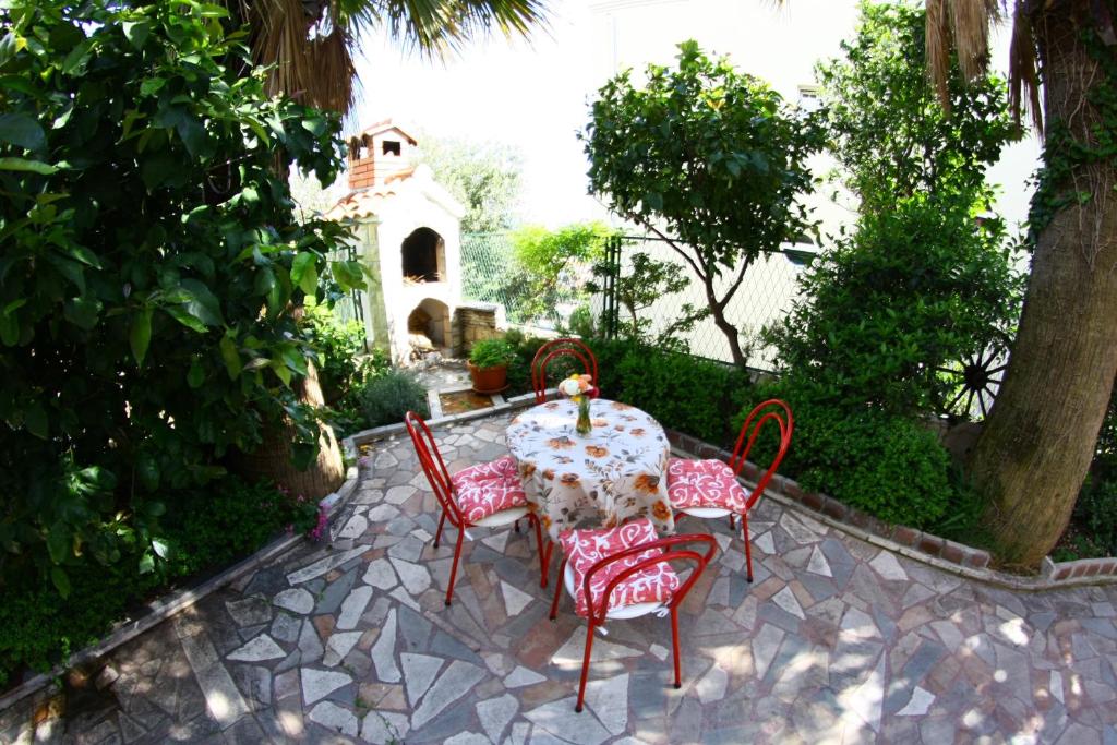a table and four chairs sitting on a patio at Apartments Maria in Podstrana