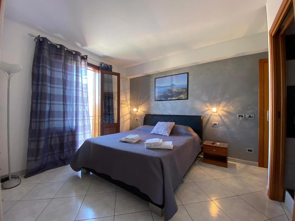 a bedroom with a bed with two towels on it at El Nur Bed & Breakfast in San Vito lo Capo