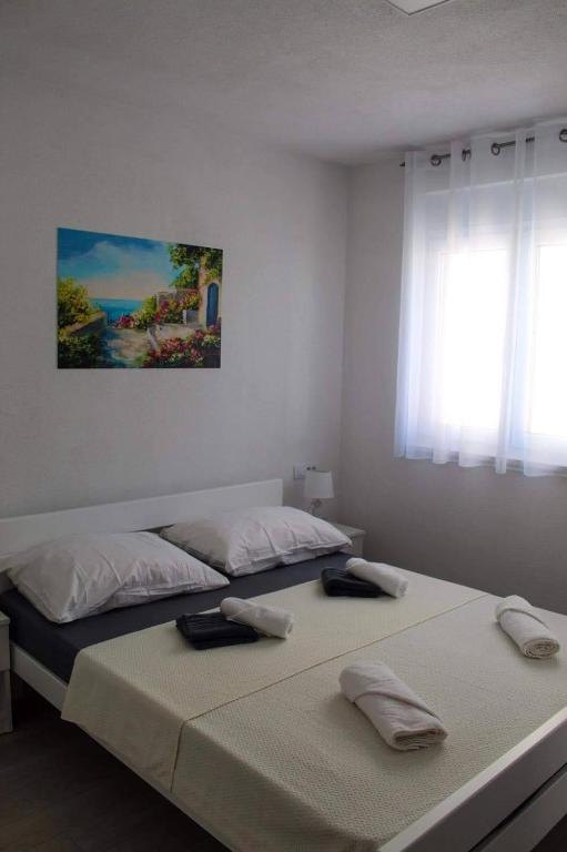 Łóżko lub łóżka w pokoju w obiekcie Apartmani Manuela
