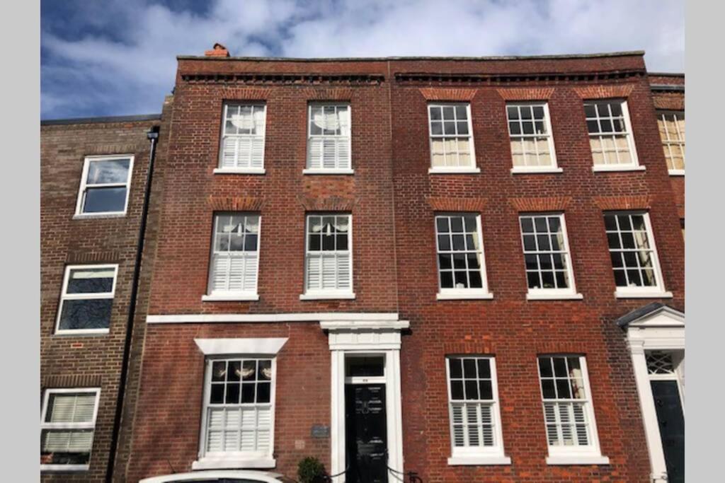 a large red brick building with white windows at Luxury 2 bed Georgian Townhouse, Old Portsmouth in Portsmouth