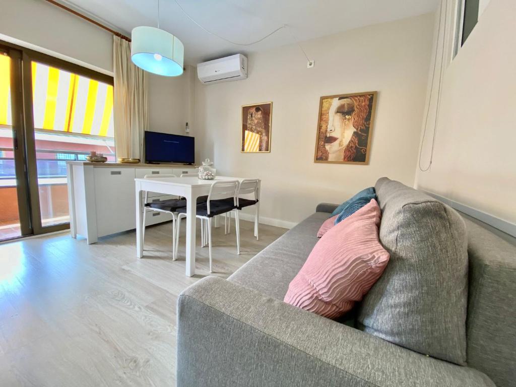 a living room with a couch and a table at Apartamentos Neptuno in Platja  d'Aro