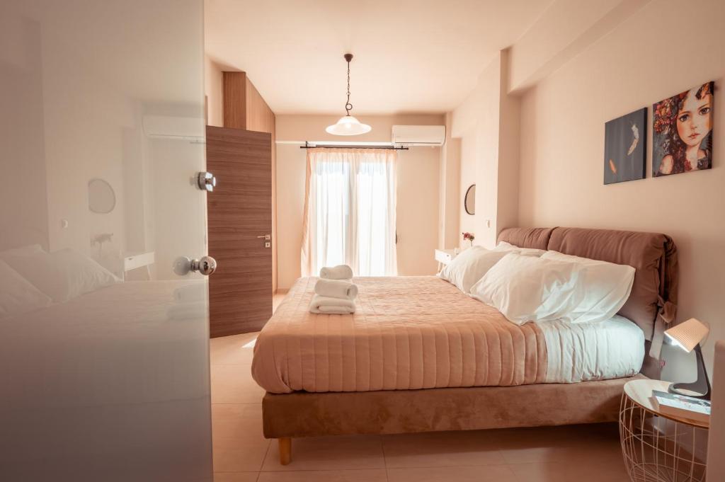 a bedroom with a bed and a door with a window at Harmony Deluxe Villa With Sea Mountain View in Kambánion