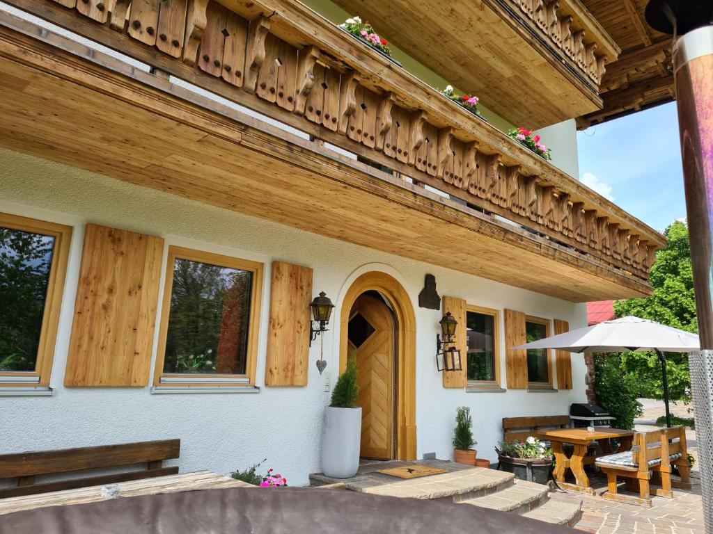 a porch of a house with a wooden roof at Ferienhaus Schnitzhof in Abtenau