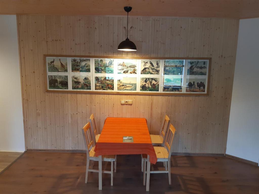 a dining room with a wooden table and chairs at Stáj Zakšín - špejchar in Dubá
