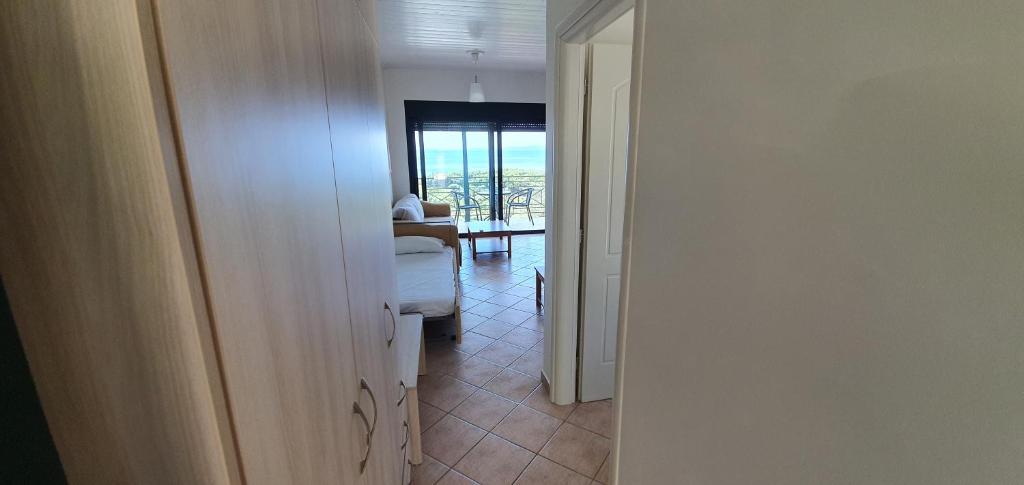 a hallway with a view of a room with a table at Sivota Apartments in Syvota