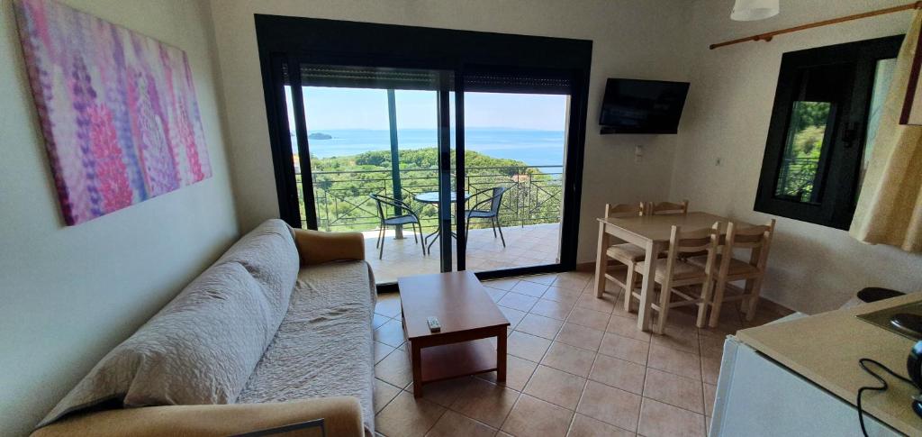 a living room with a couch and a table at Sivota Apartments in Syvota