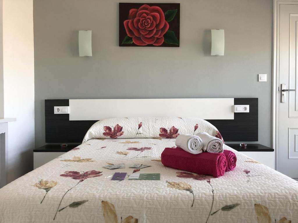 ein Schlafzimmer mit einem Bett mit zwei Handtüchern darauf in der Unterkunft Dukes Habitaciones in Bascuas