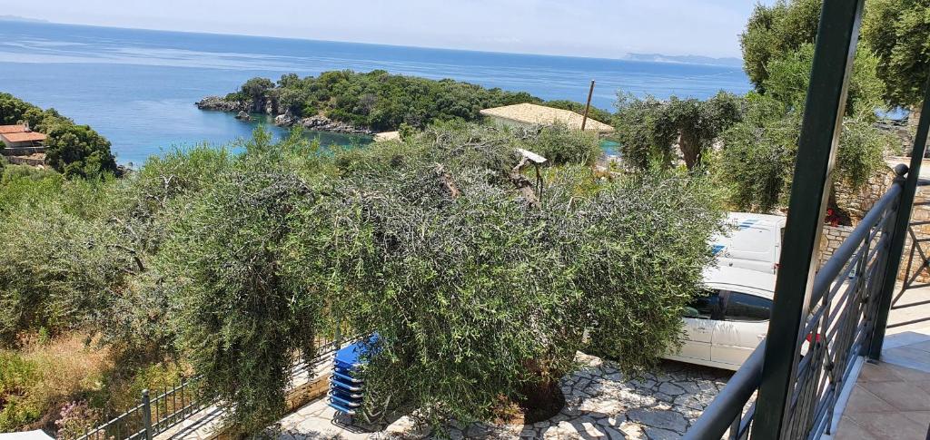 a white car parked on a balcony overlooking the water at Sivota Apartments in Syvota