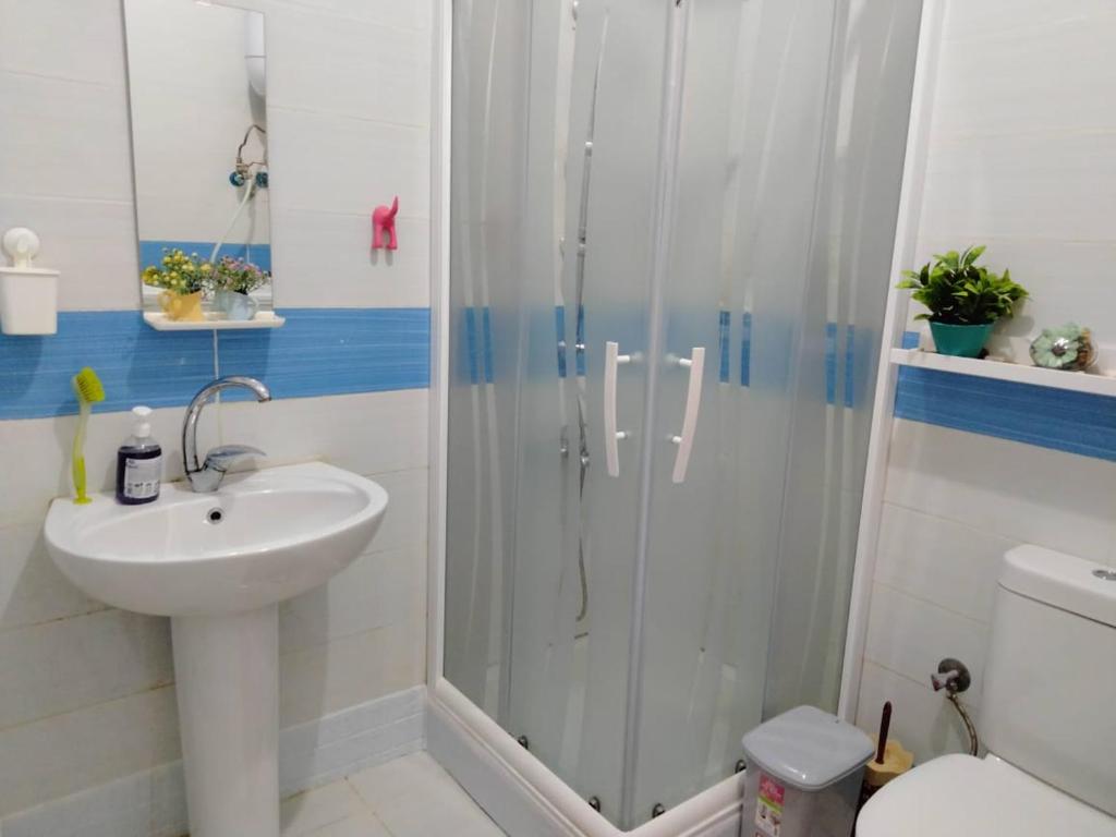a bathroom with a shower and a sink and a toilet at Modern Chalet at Royal Beach resort in Marsa Matruh