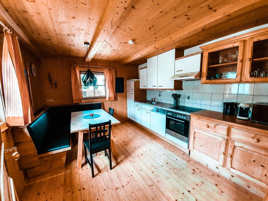 a kitchen with a wooden floor and a table in it at Ferienhaus Berger in Virgen