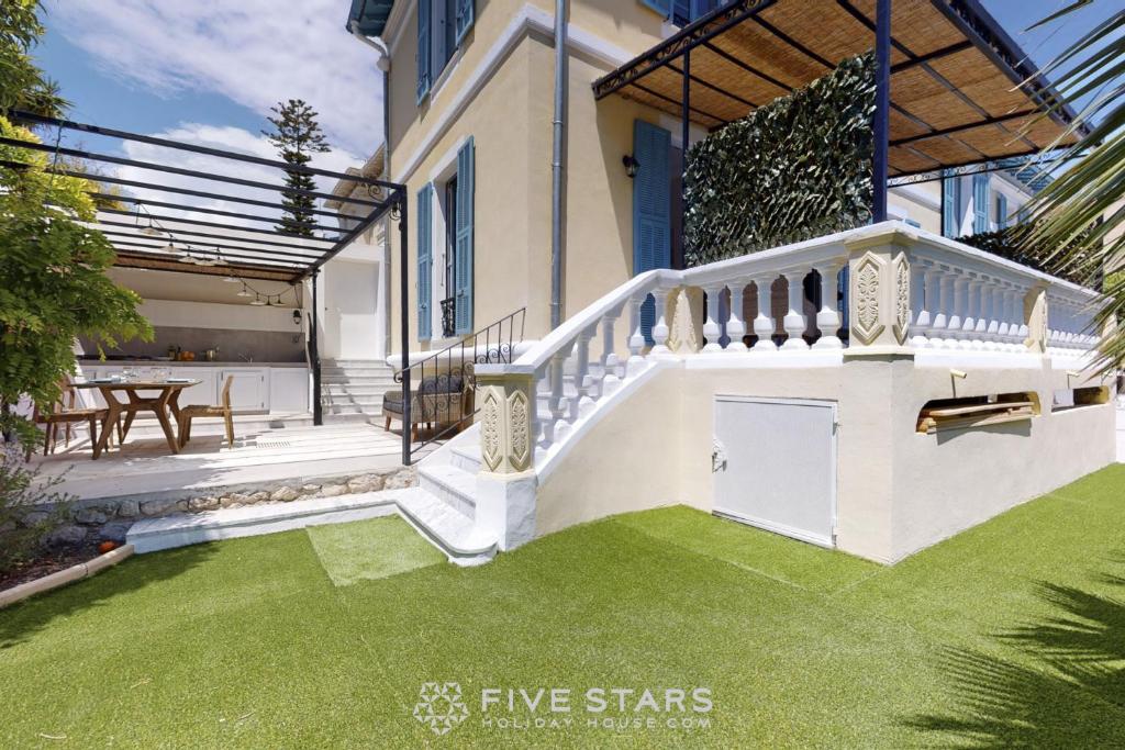 dom z ogródkiem z zieloną trawą w obiekcie Villa Capriciosa - Five Stars Holiday House w mieście Beaulieu-sur-Mer