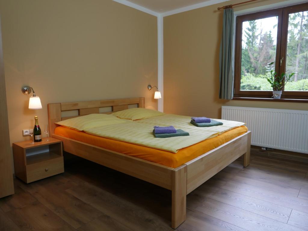 a bedroom with a bed with two towels on it at Pension Aspen Harrachov in Harrachov