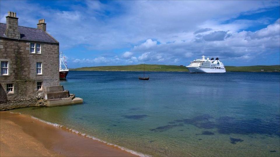 a cruise ship in a large body of water at Queens Hotel in Lerwick