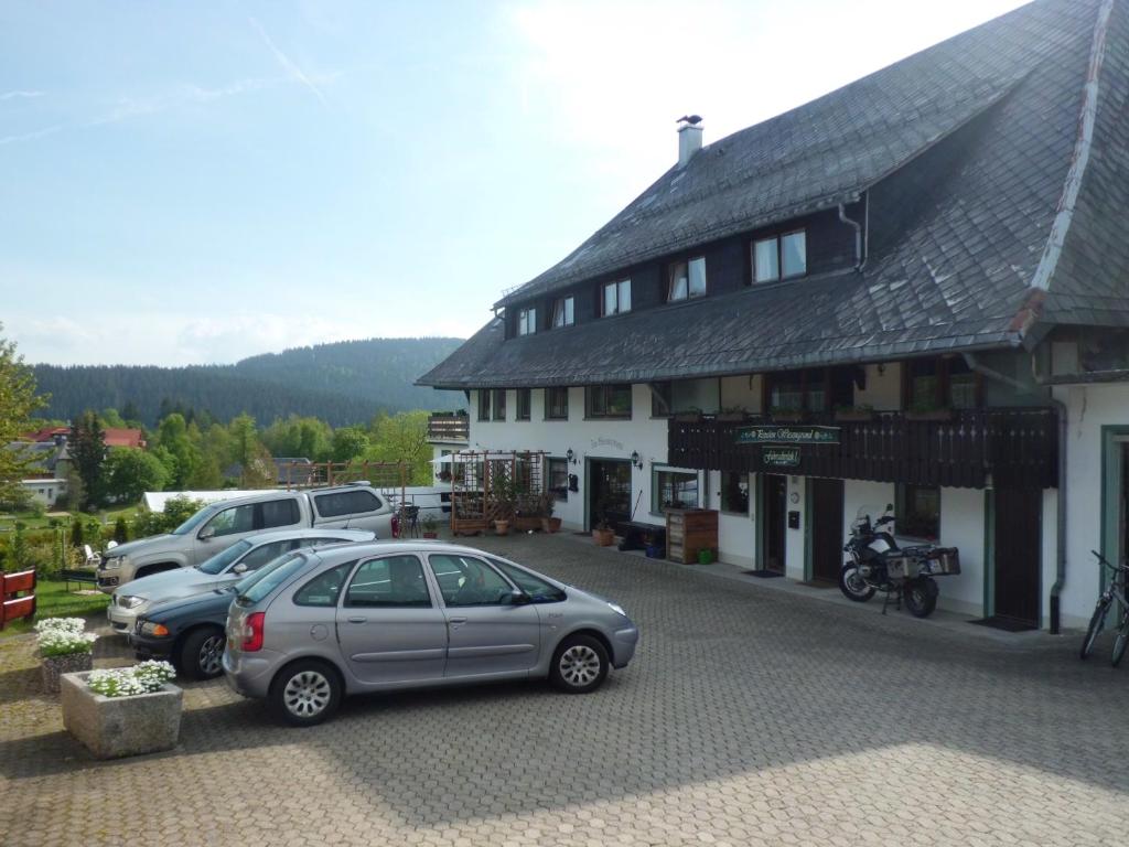 a large building with cars parked in front of it at Pension Wiesengrund in Schluchsee