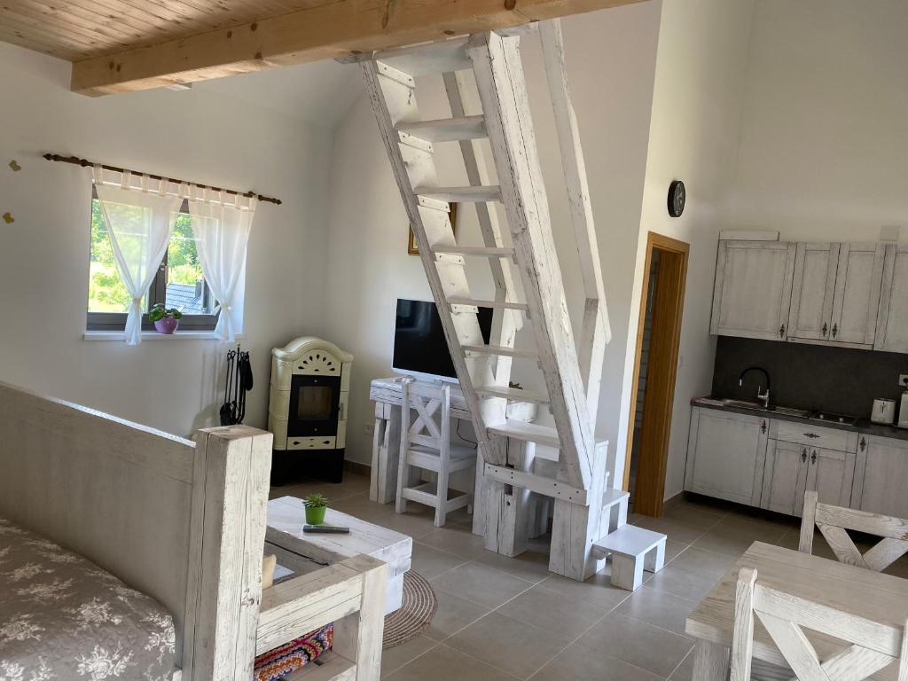 a living room with a white ladder in a room at Apartment I&M in Plitvička Jezera