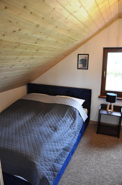 Posteľ alebo postele v izbe v ubytovaní Zagroda Mazury -,,Domki nad Rozlewiskiem"