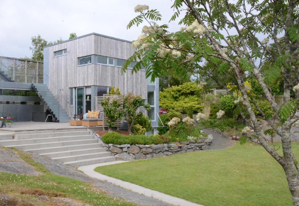 a house with a garden in front of it at Villa Vassøy in Stavanger