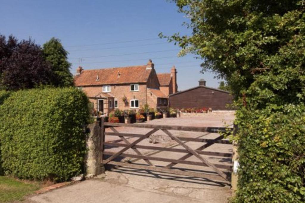 a wooden fence in front of a house at Brecks Cottage in Newark upon Trent