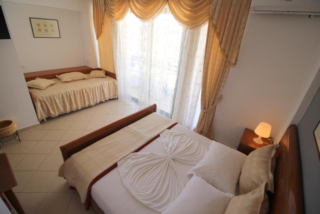 Postel nebo postele na pokoji v ubytování Olympia Hotel