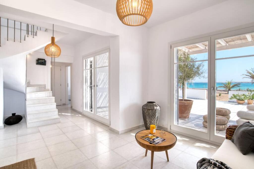 a living room with a view of the ocean at The view 1 in Kampos Paros