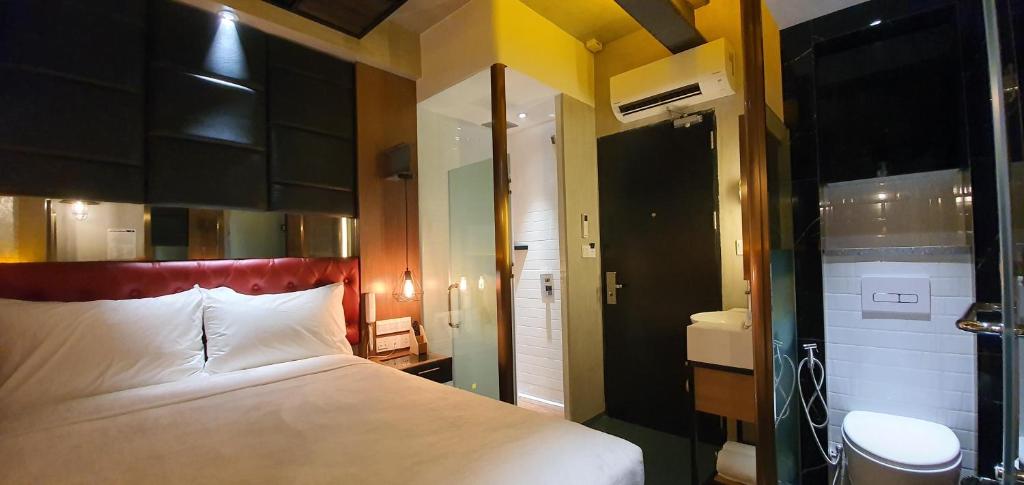A bed or beds in a room at iOtel Luxury Kiosk Hotel