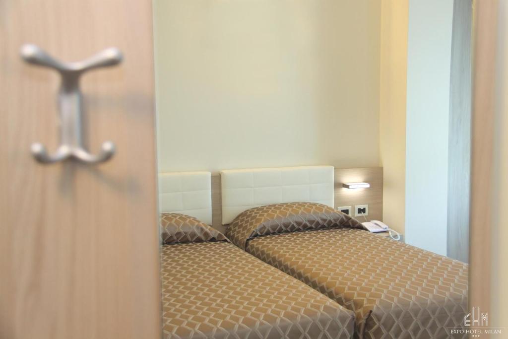 Postel nebo postele na pokoji v ubytování Expo Hotel Milan