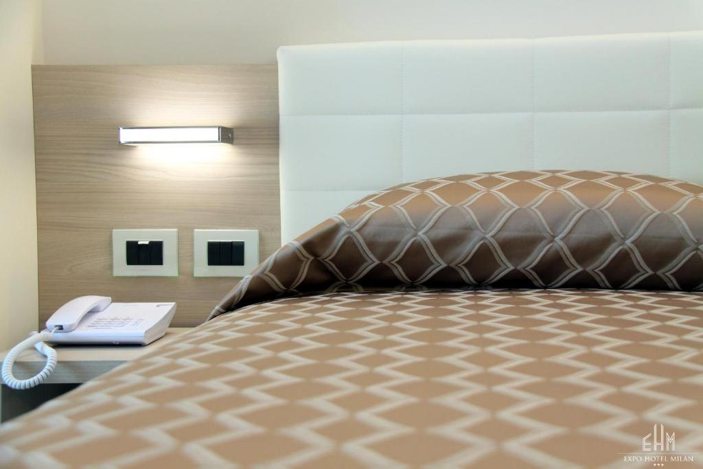 Postel nebo postele na pokoji v ubytování Expo Hotel Milan