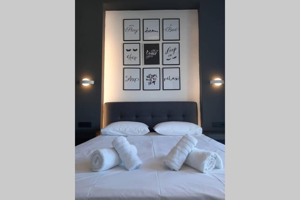 een slaapkamer met een bed met witte kussens erop bij Luxury 1 bedroom apartment in Ialysos in Ialyssos