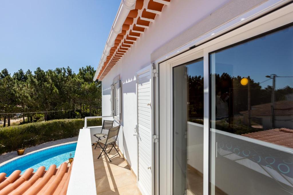 a balcony with a view of a swimming pool at Villa Flavia in Aljezur