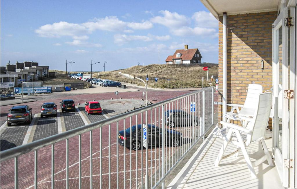 a balcony with cars parked in a parking lot at Zeebalkon in Bergen aan Zee