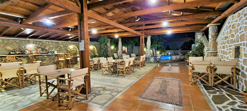 a restaurant with tables and chairs on a patio at Kastro Hotel in Spetses