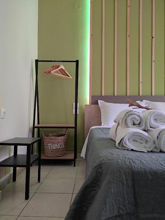 a bedroom with a bed and a table and a mirror at Poseidon Rooms in Kala Nera