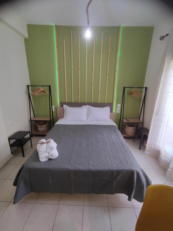 a bedroom with a bed with two towels on it at Poseidon Rooms in Kala Nera