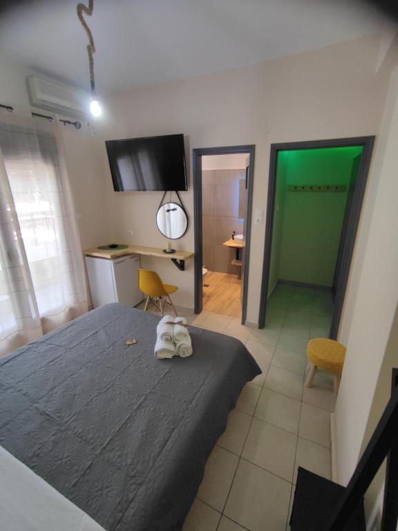 a bedroom with a bed and a room with a desk at Poseidon Rooms in Kala Nera