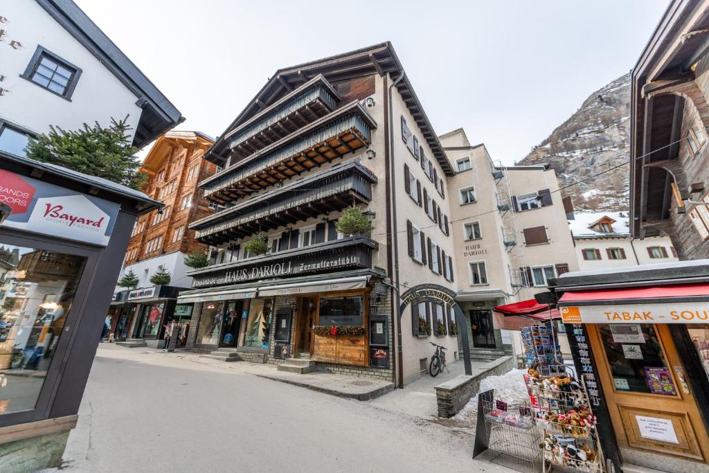 a street in a city with shops and buildings at Haus Darioli in Zermatt