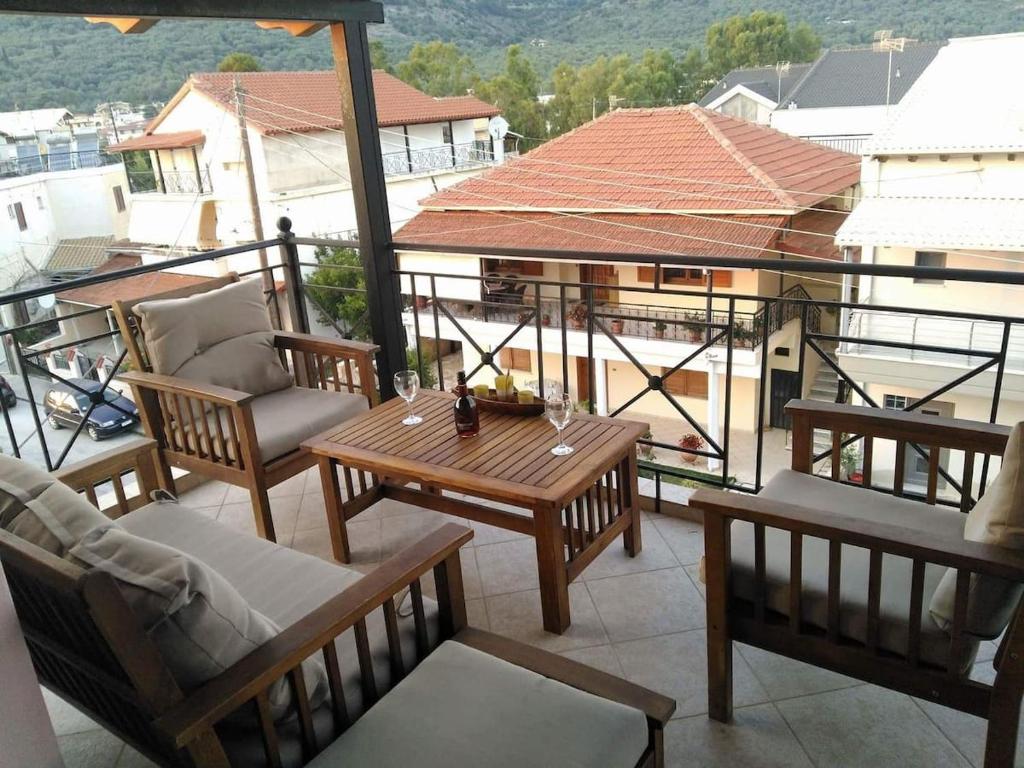 a balcony with a table and chairs on a building at View and Relax Apartment in Plataria