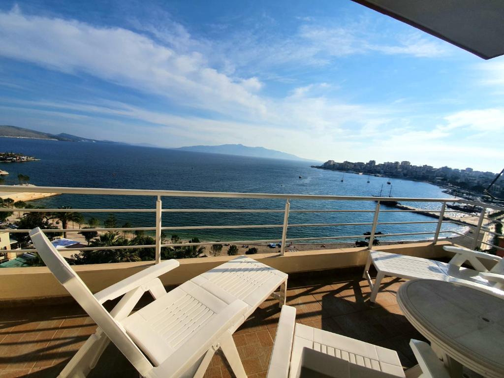 a balcony with chairs and a view of the ocean at Alba Apartments in Sarandë