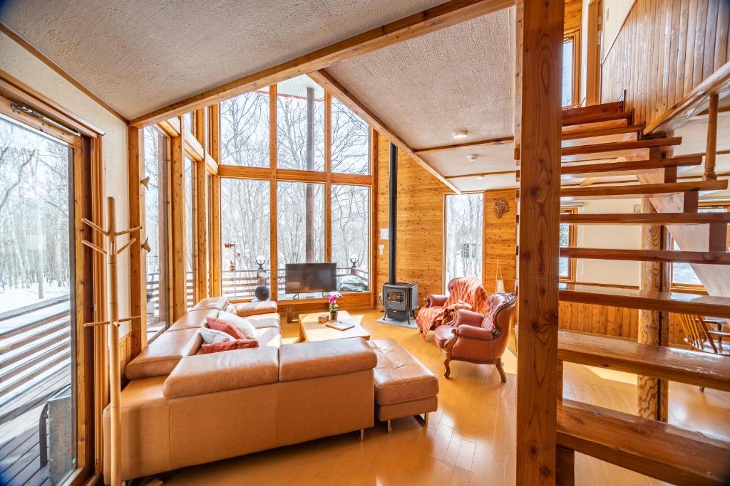 a living room with two couches and a tv at Matsu House - 5 min walk to Rusutsu Ski Resort in Rusutsu
