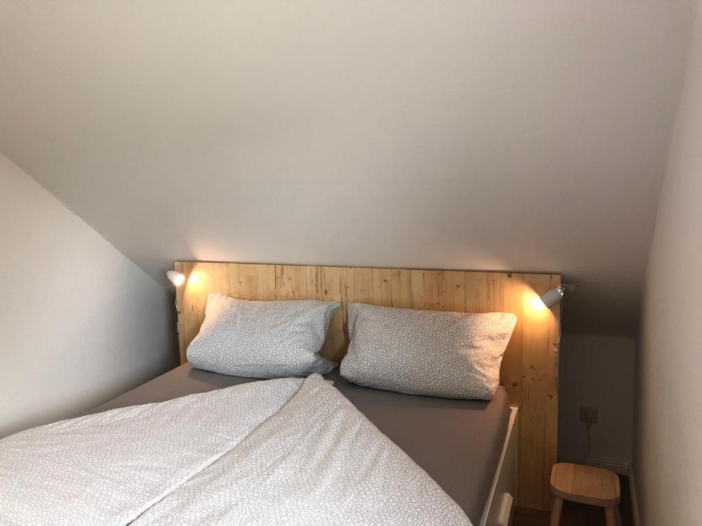 a small bedroom with a bed with two white pillows at Ankerplatz Langballig in Langballig