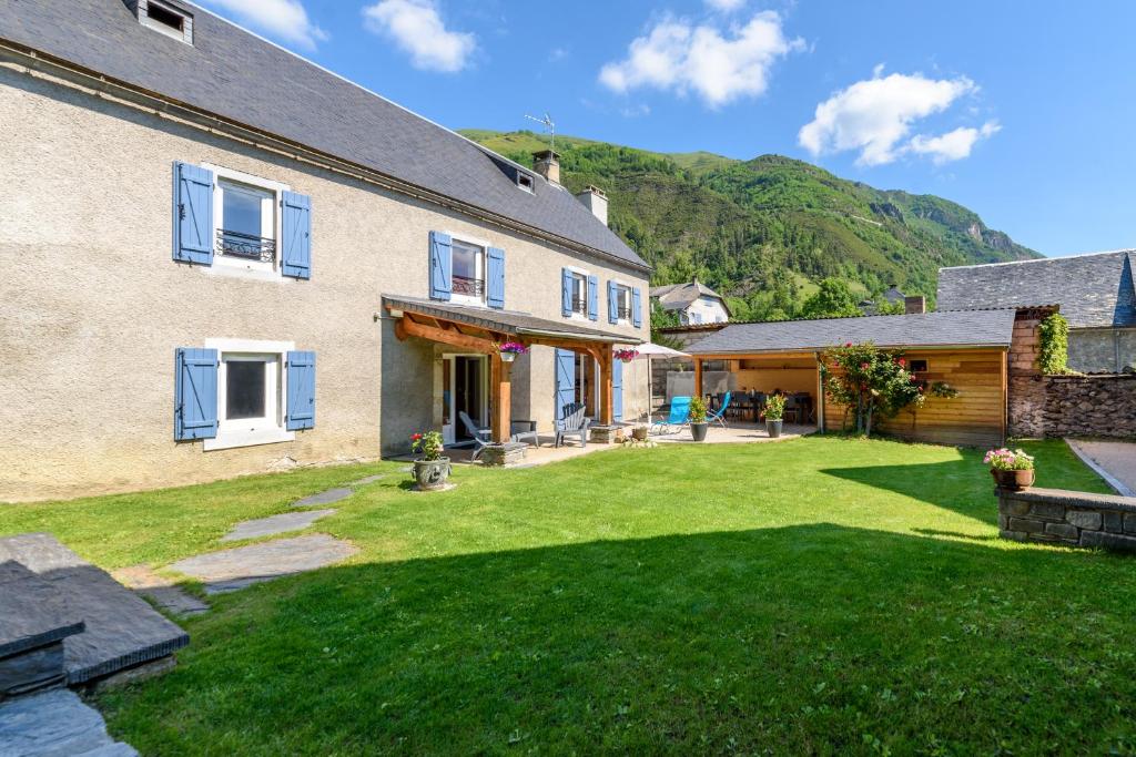 a house with a yard with green grass at St Lary/Vignec: Les 3 Flocons in Vignec