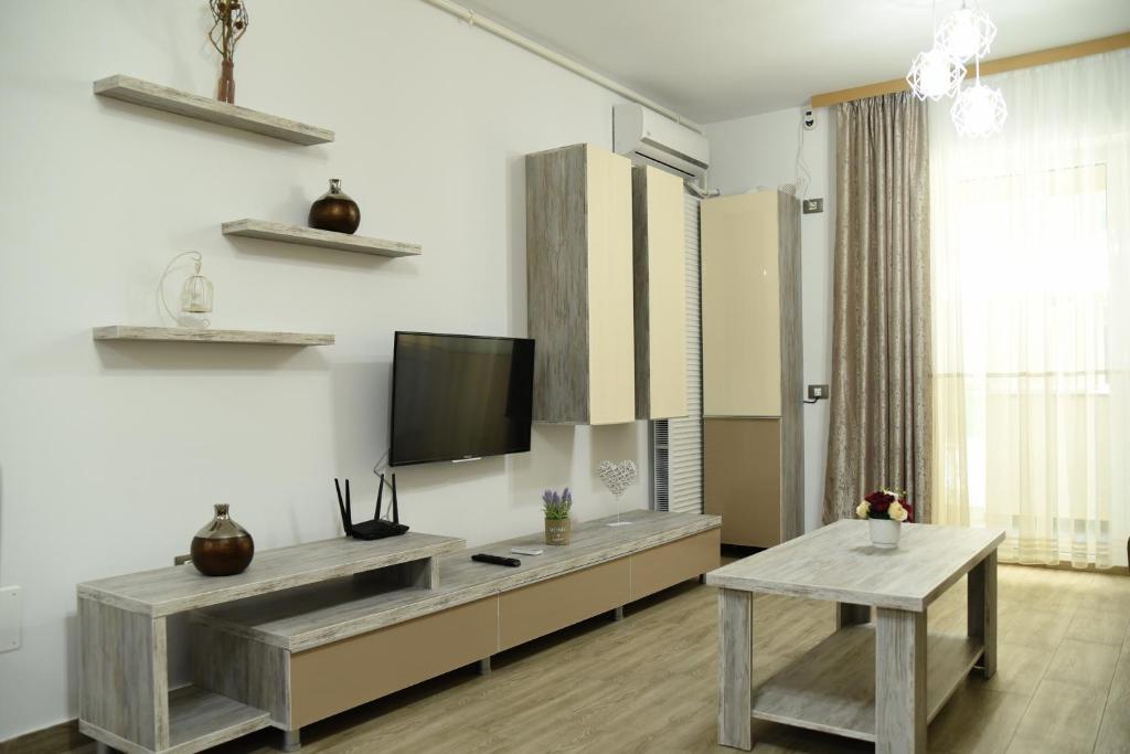 a living room with a flat screen tv on a wall at Ideal MoonLight Residence in Mamaia