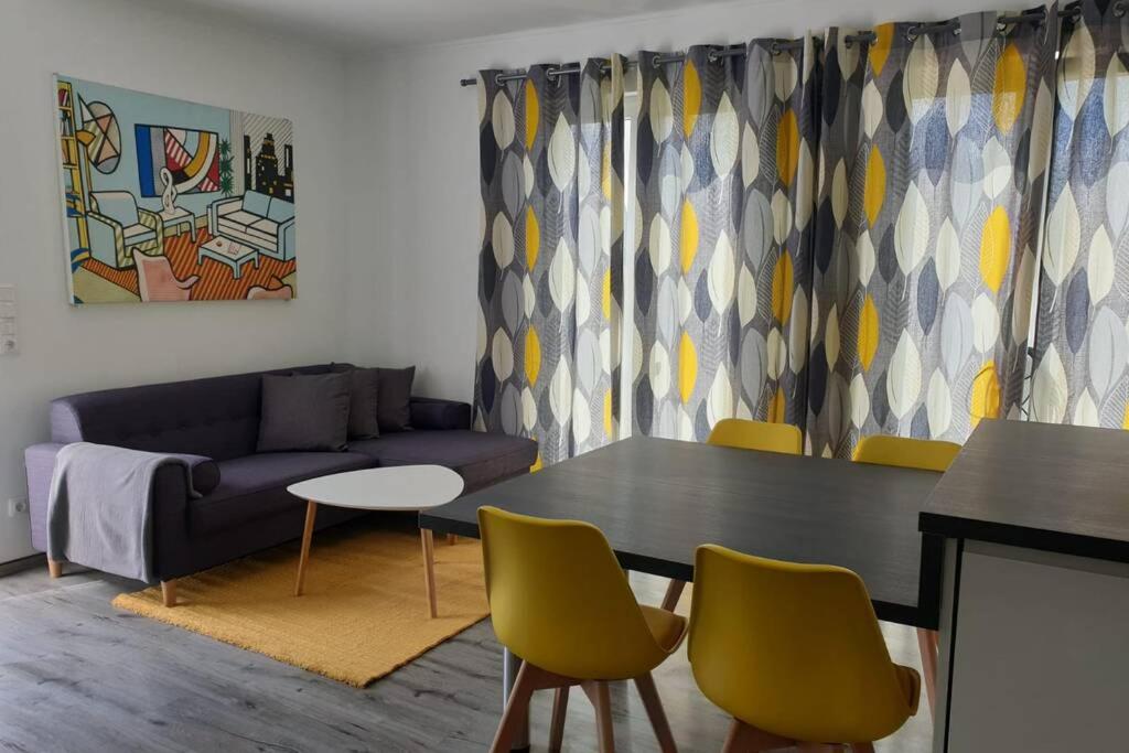a living room with a couch and a table and chairs at Ferienhaus Strandoase Nr.2 in Oldenburg in Holstein