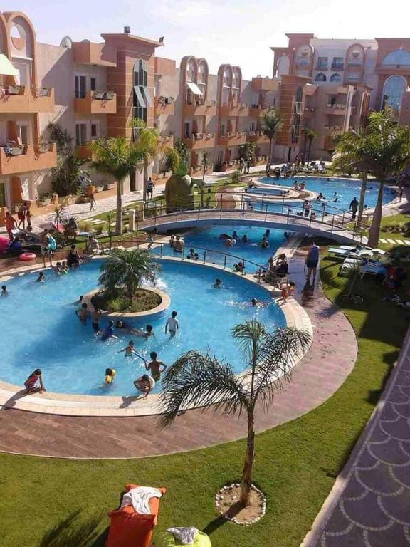 a group of people in a large swimming pool at Appartement S 1 résidence les Dunes sousse avec piscine in Sousse