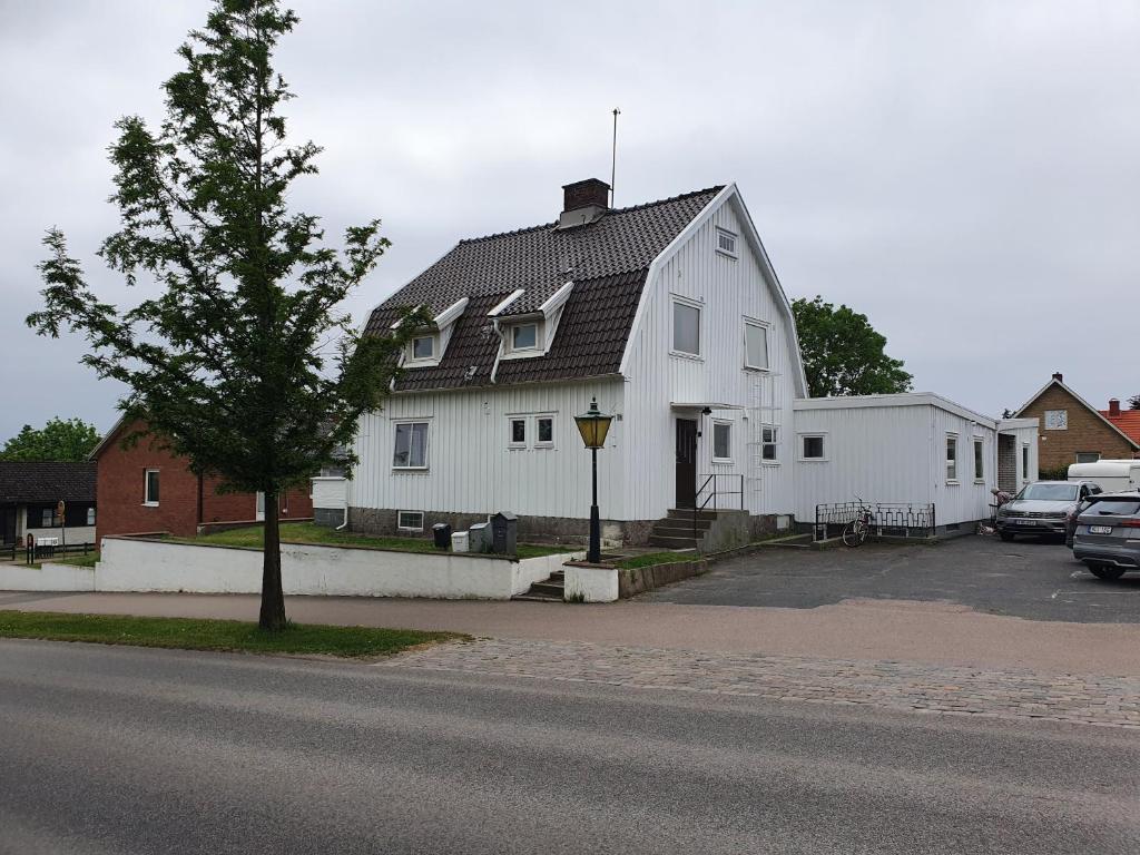 a large white house with a tree in front of it at Centralt i Falkenberg in Falkenberg