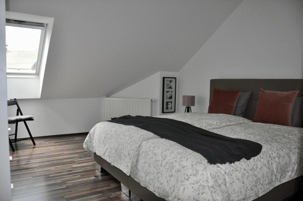 a bedroom with a large bed and a window at Appartment Pri Nacu in Bled