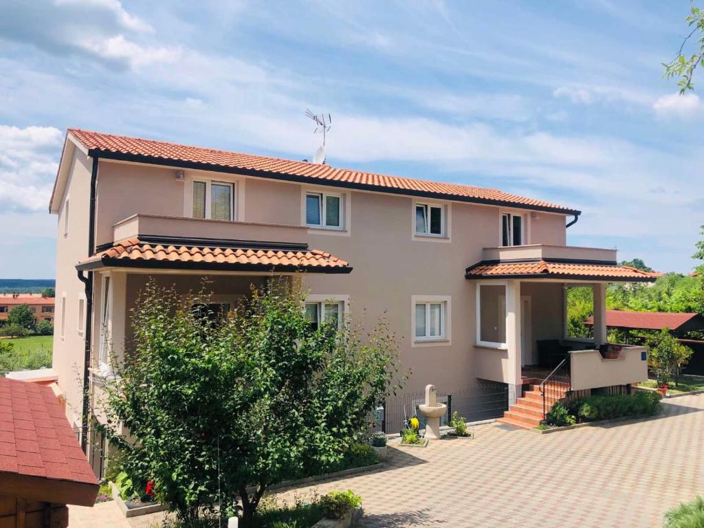 a large house with a driveway in front of it at Apartments Zdenka in Labin