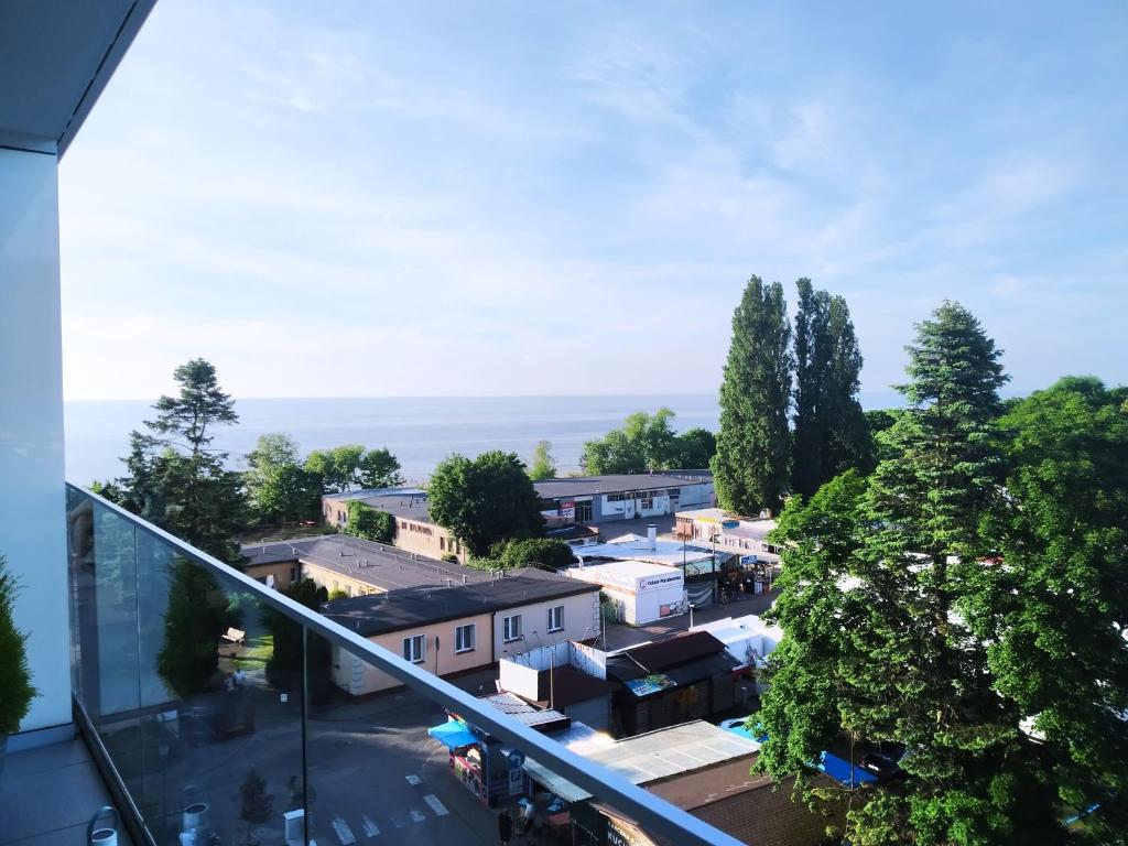 a view of a small town from a glass balcony at Balticus Apartament Premium in Międzyzdroje