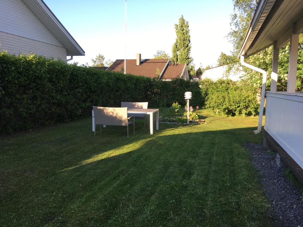a garden with a table and a chair in the grass at Apartment with garden and teracce in Oulu