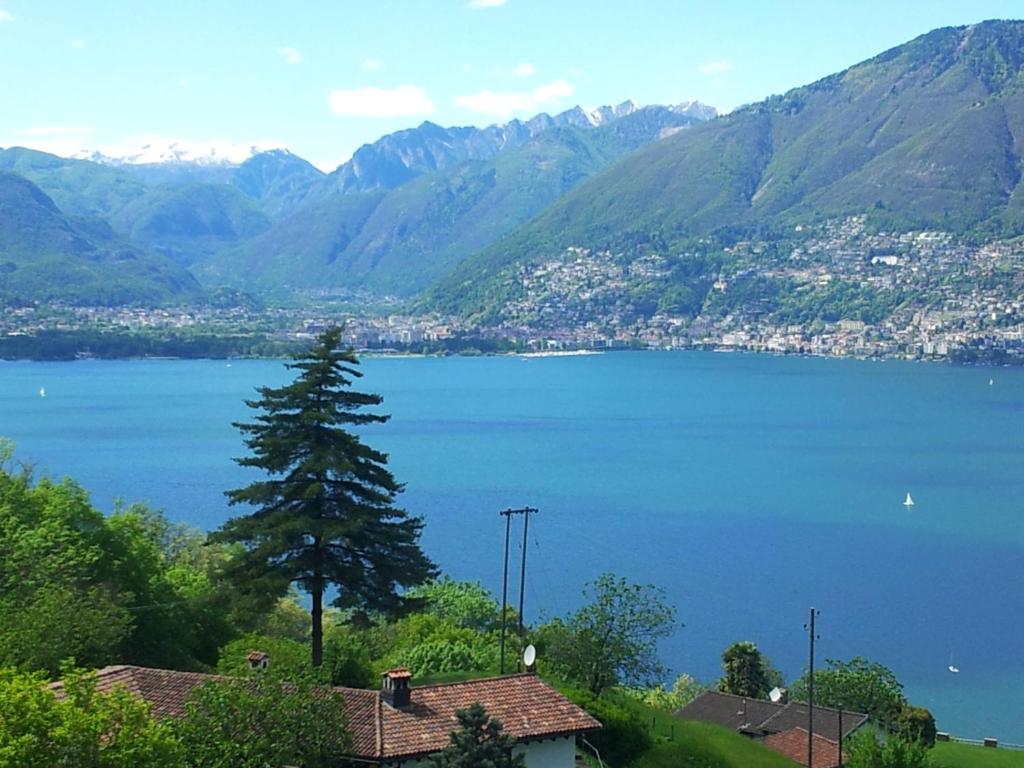 a view of a large body of water with mountains at Casa Petra in Magadino
